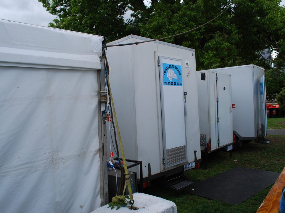 Large 9x5 cool room trailers lined up beside an event marquee