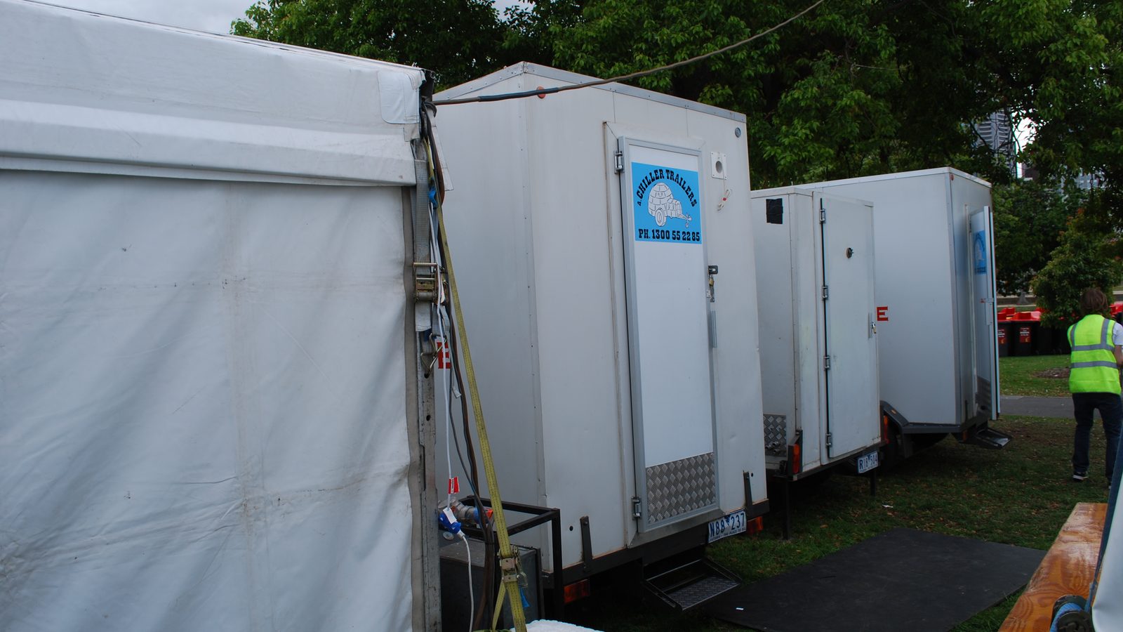 Row of mobile cool rooms set up beside a marquee at a Melbourne event